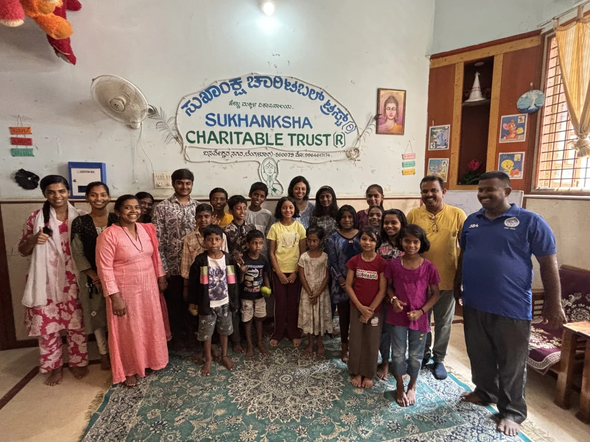 Children and supporters gathered during a community visit