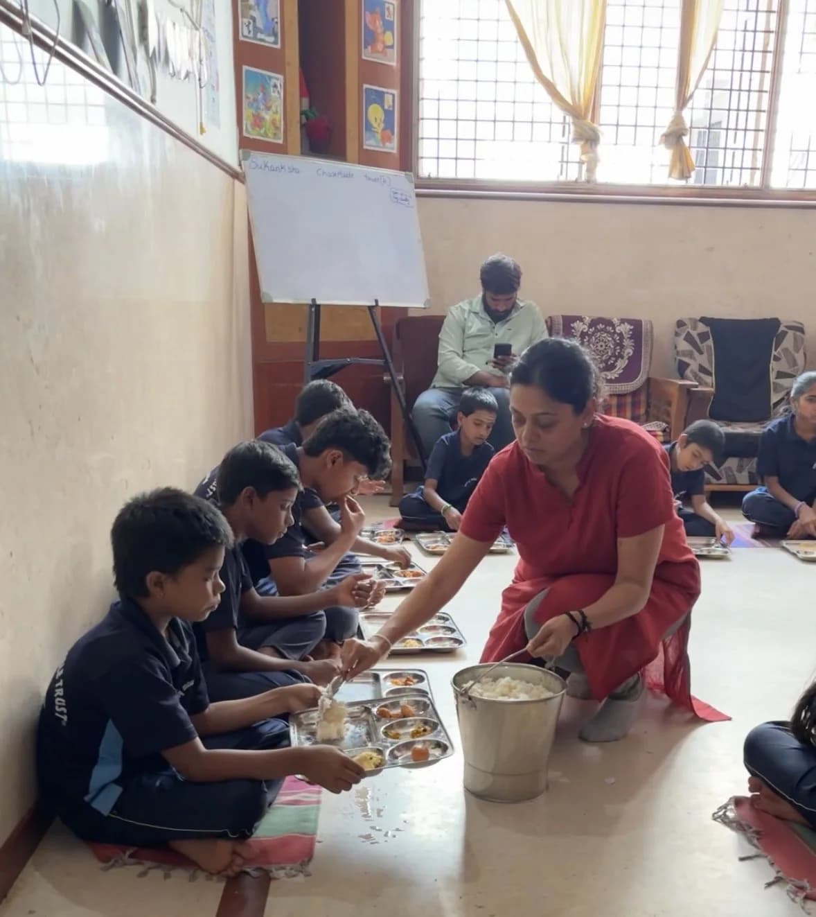 Neha serving a meal during a community visit